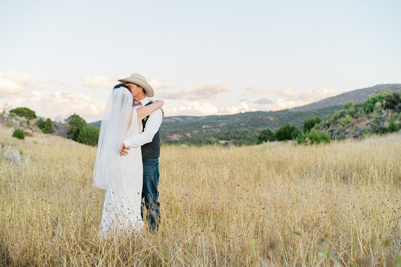 bride and groom sunset photo in a field with tall grass at a ranch in Arizona